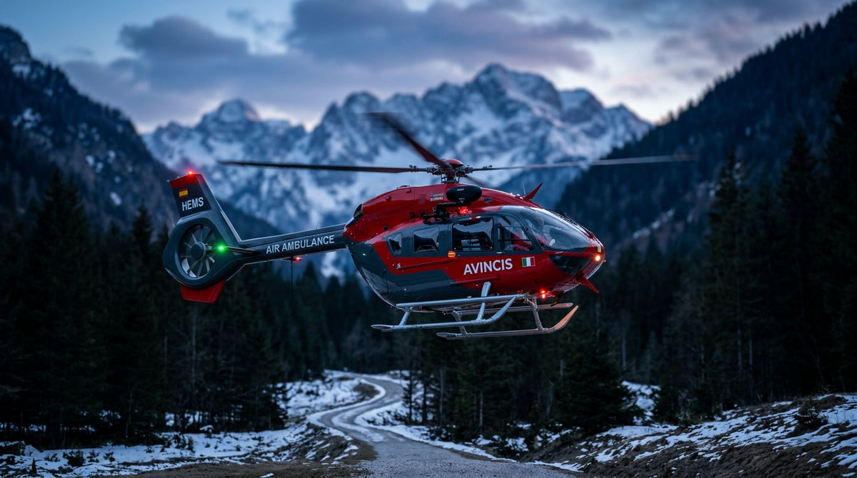 Avincis Airbus H145 emergency medical helicopter in red livery hovering over an alpine valley at dusk