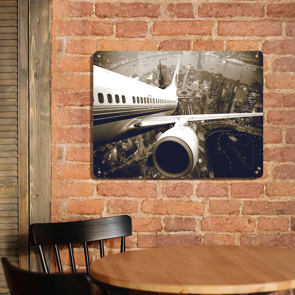 Departing Aircraft & City Scene behind Printed Metal Sign