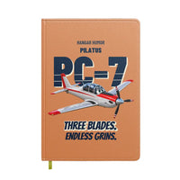 Thumbnail for Pilatus PC-7 - Three blades. Endless grins. design on orange notebook