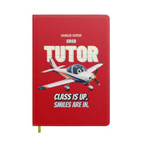 Thumbnail for Grob G 115E Tutor - Class is up. Smiles are in. design on red notebook