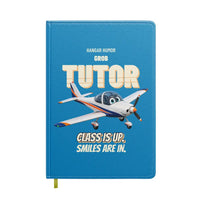 Thumbnail for Grob G 115E Tutor - Class is up. Smiles are in. design on turquoise notebook