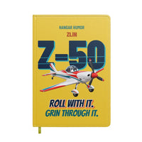 Thumbnail for Zlin Z-50LS - Roll with it. Grin through it. design on yellow notebook