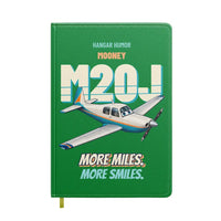 Thumbnail for Mooney M20J - More miles. More smiles. design on green notebook
