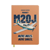 Thumbnail for Mooney M20J - More miles. More smiles. design on orange notebook