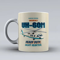 Thumbnail for Sikorsky UH-60M Black Hawk - Heavy duty. Light hearted. design on beige ceramic mug