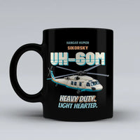 Thumbnail for Sikorsky UH-60M Black Hawk - Heavy duty. Light hearted. design on black ceramic mug