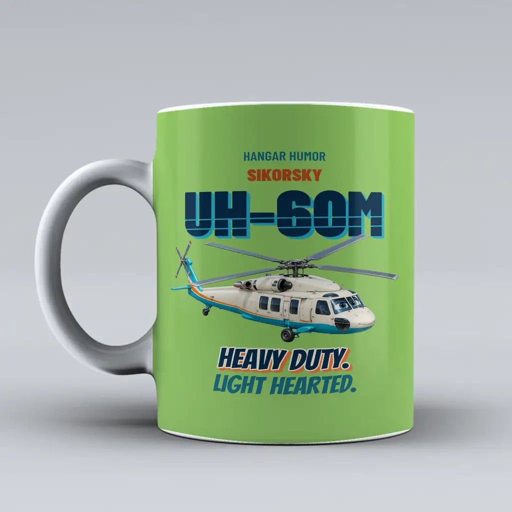 Sikorsky UH-60M Black Hawk - Heavy duty. Light hearted. design on light green ceramic mug