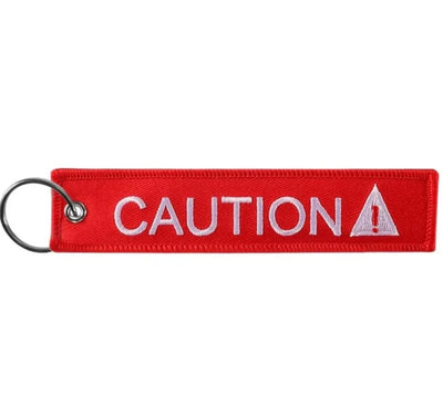 Caution (Red) aviation fashion key chain in polished metal.