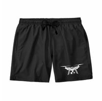Thumbnail for Drone Silhouette aviation design on quick-dry polyester swim trunks.