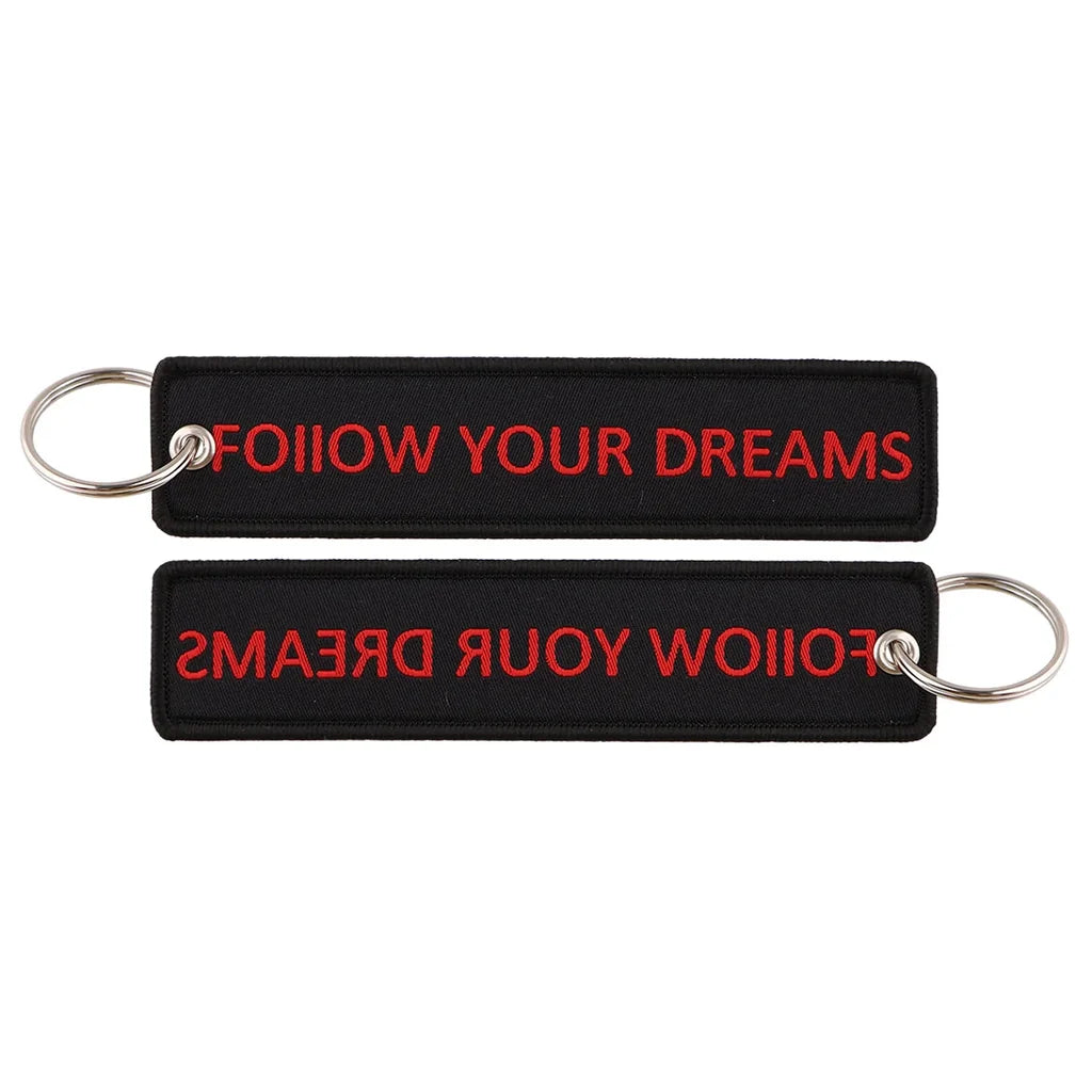 FOLLOW YOUR DREAMS aviation fashion key chain in polished metal.