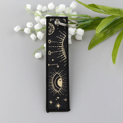Star Eye & Moon Whisper aviation fashion key chain in polished metal.