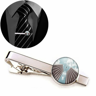 Airplane Flying over Big Buildings aviation-themed tie clip, polished stainless steel.