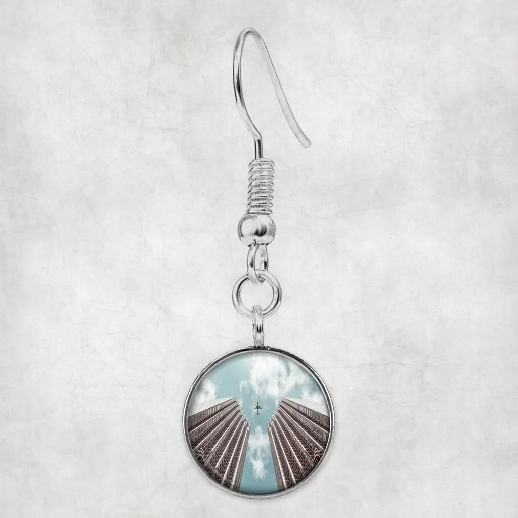Airplane Flying over Big Buildings aviation-themed earrings, polished hypoallergenic alloy.