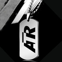 Thumbnail for ATR & Text aviation necklace, polished metal body with engraved detail.