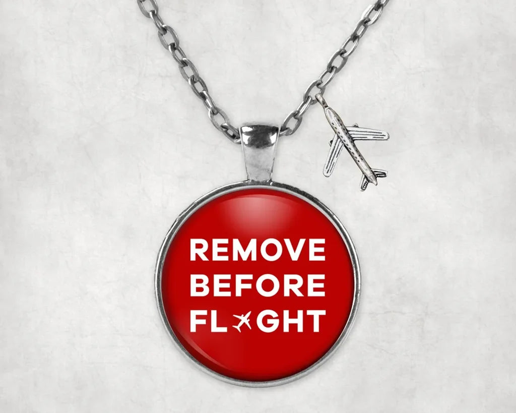 Remove Before Flight aviation-themed necklace, polished stainless steel.