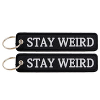 Thumbnail for STAY WEIRD aviation fashion key chain in polished metal.