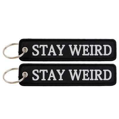 STAY WEIRD aviation fashion key chain in polished metal.