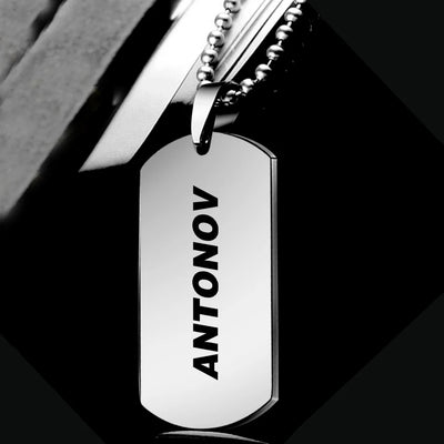 Antonov & Text aviation necklace, polished metal body with engraved detail.
