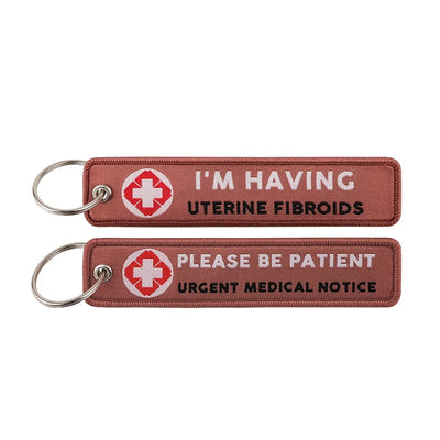 I'M HAVING UTERINE FIBROIDS PLEASE BE PATIENT URGENT MEDICAL NOTICE aviation fashion key chain in polished metal.