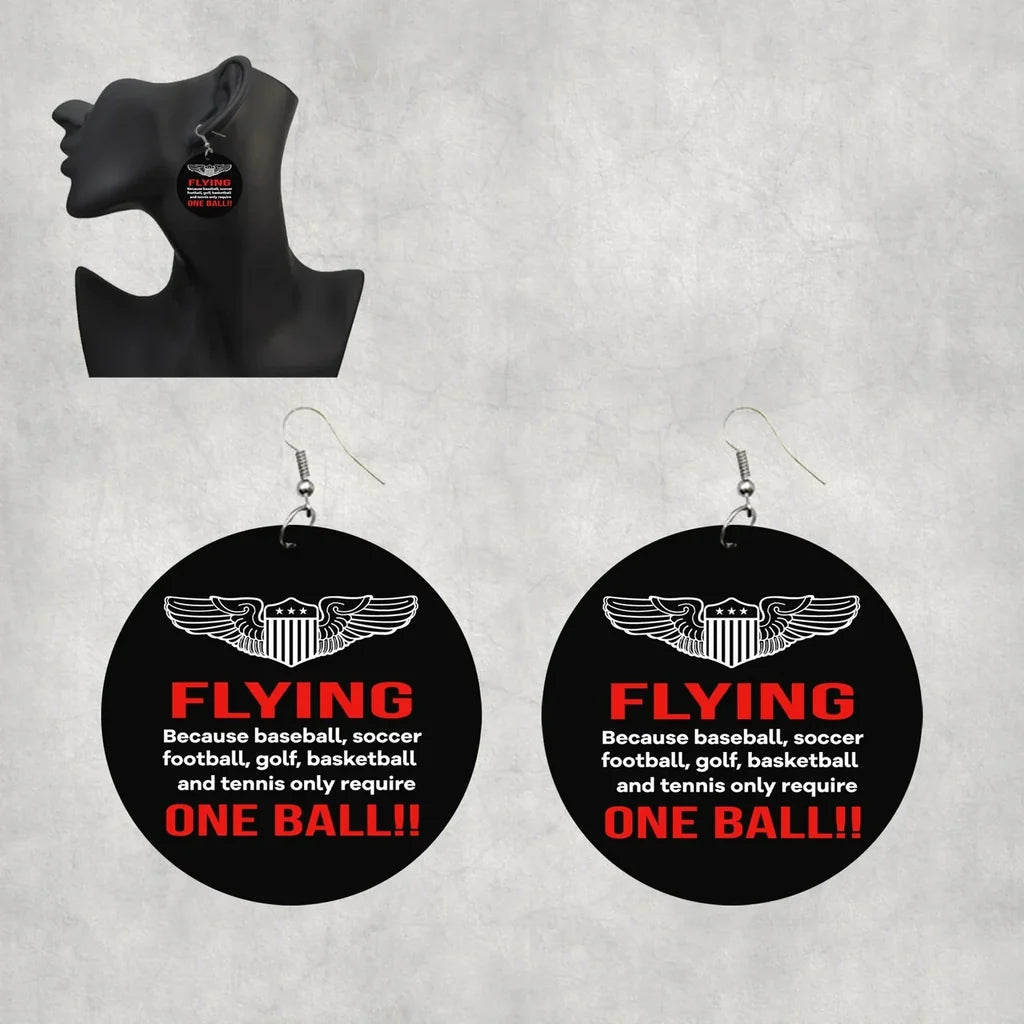 Flying One Ball aviation-themed drop earrings, polished wood with metal hooks.