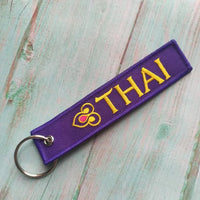 Thumbnail for Thai Airways aviation Remove Before Flight key chain, aviation-tag style webbing.