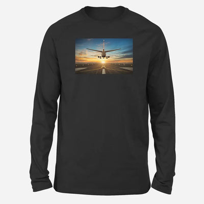 Airplane over Runway Towards the Sunrise Long-Sleeve aviation design printed on soft cotton long-sleeve T-shirt.