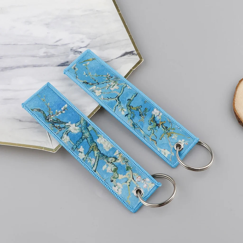 Almond Blossoms aviation fashion key chain in polished metal.
