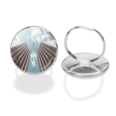 Airplane Flying over Big Buildings aviation ring in stainless steel.