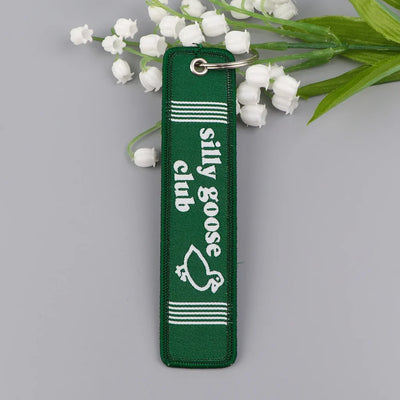Silly Goose Club aviation fashion key chain in polished metal.