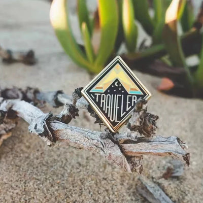 Traveler aviation design on polished metal badge.