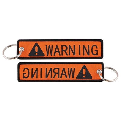WARNING aviation fashion key chain in polished metal.