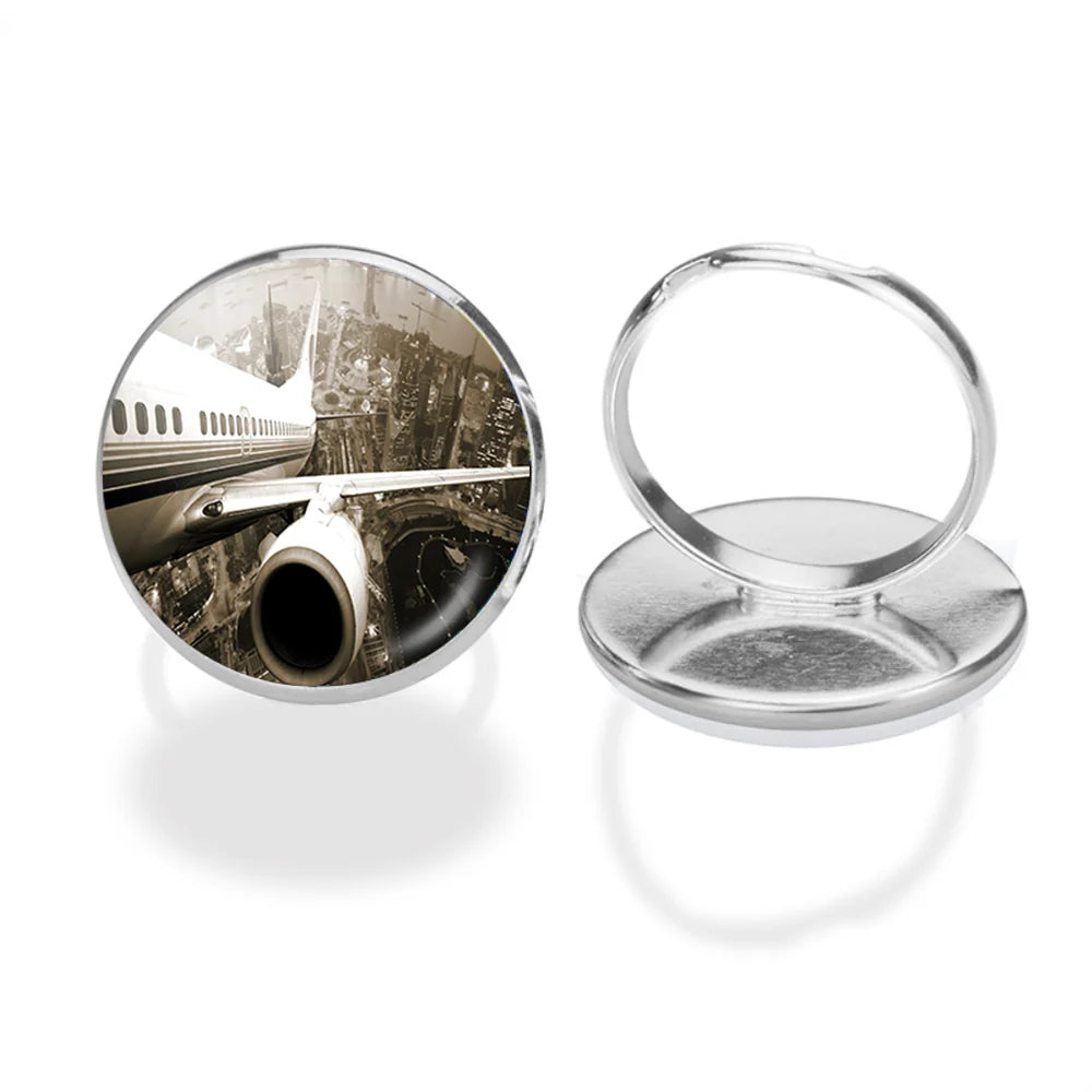 Departing Aircraft & City Scene behind aviation ring in stainless steel.