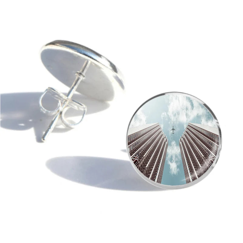 Side view of Airplane Flying over Big Buildings aviation stud earrings in stainless steel, polished finish.