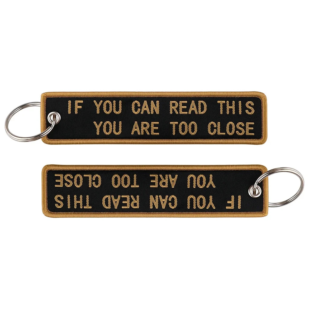 IF YOU CAN READ THIS YOU ARE TOO CLOSE aviation fashion key chain in polished metal.