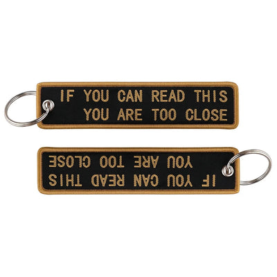 IF YOU CAN READ THIS YOU ARE TOO CLOSE aviation fashion key chain in polished metal.