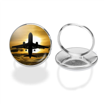 Departing Passanger Jet During Sunset aviation ring in stainless steel.
