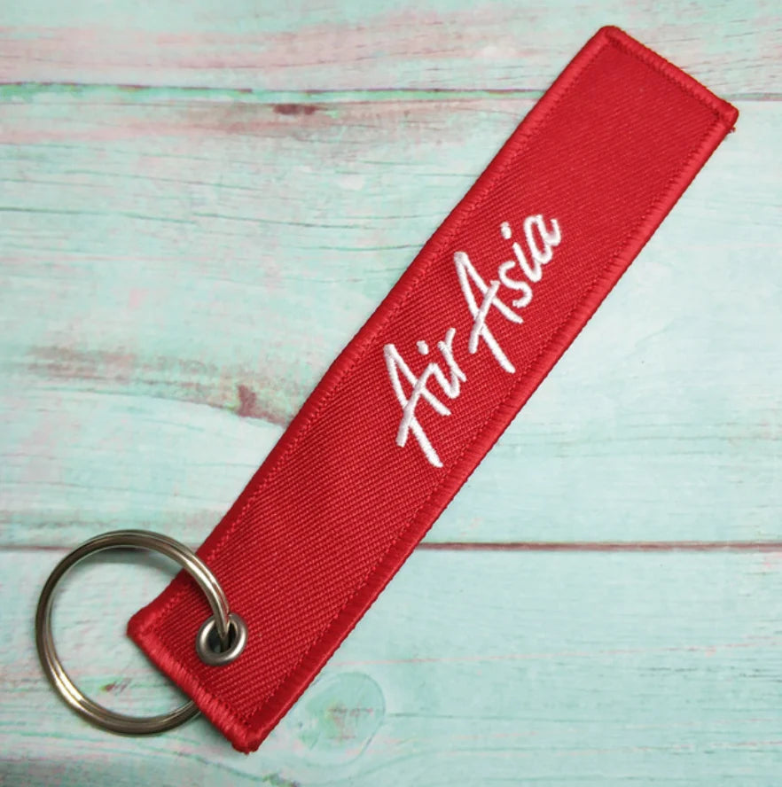 Air Asia aviation Remove Before Flight key chain, aviation-tag style webbing.