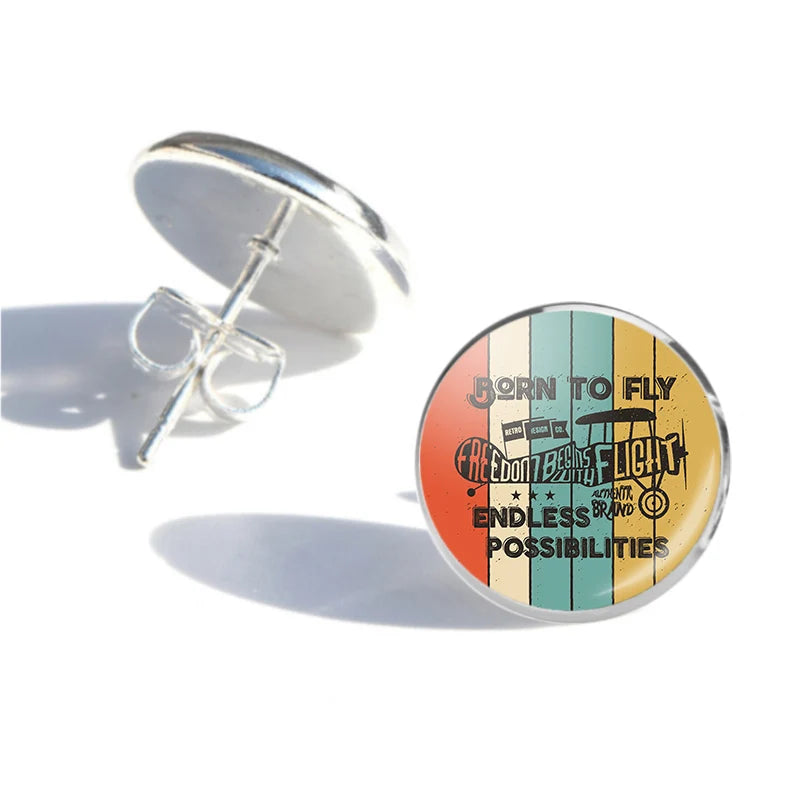 Colourful Born To Fly aviation stud earrings, stainless steel body with engraved detail.