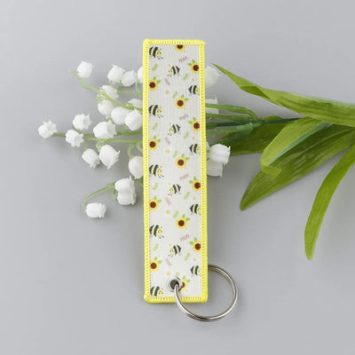 Bee & Sunflower Warmth aviation fashion key chain in polished metal.