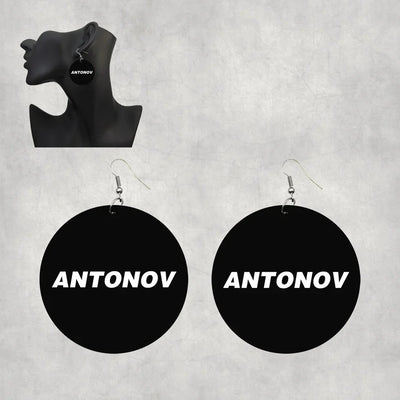 Side view of Antonov & Text aviation drop earrings in wood with metal hooks, polished finish.