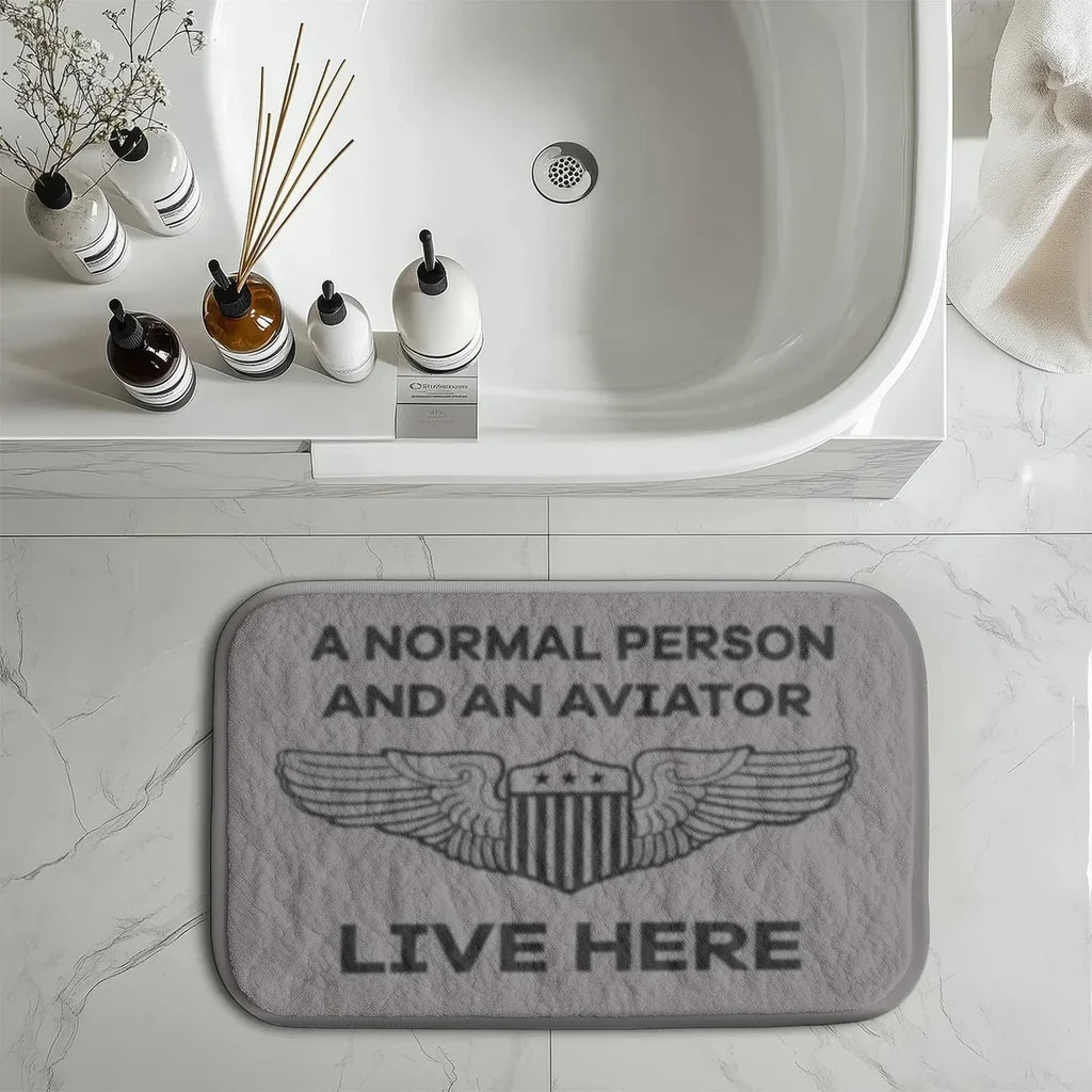 A Normal Person and an AVIATOR Live Here aviation print bath mat, soft absorbent fabric with non-slip backing.