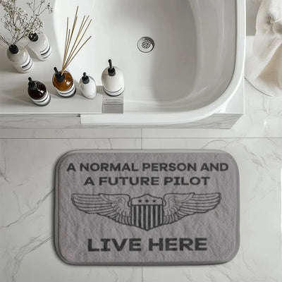 A Normal Person and a FUTURE PILOT Live Here aviation print bath mat, soft absorbent fabric with non-slip backing.