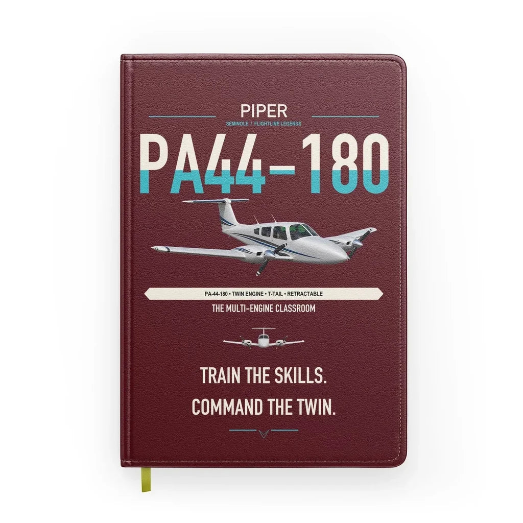 Piper PA-44-180 Seminole design on dark red notebook