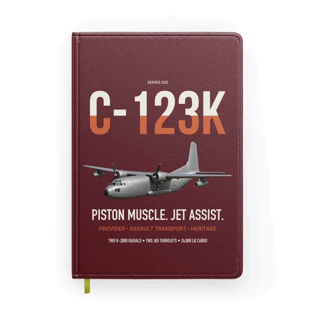 C-123K Provider design on dark red notebook
