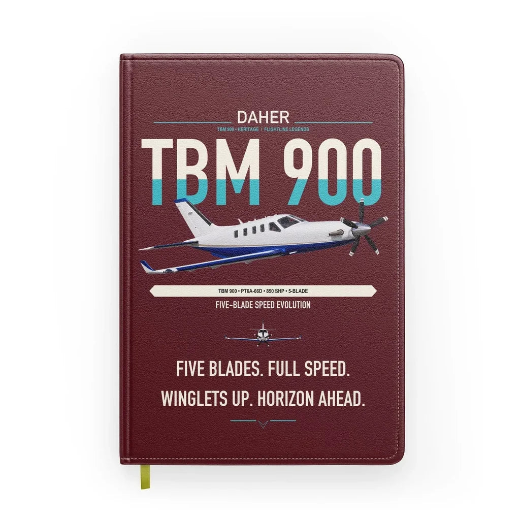 Daher TBM 900 design on dark red notebook