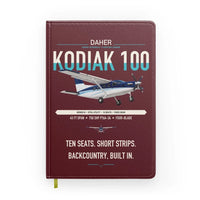 Thumbnail for Daher Kodiak 100 Series III design on dark red notebook