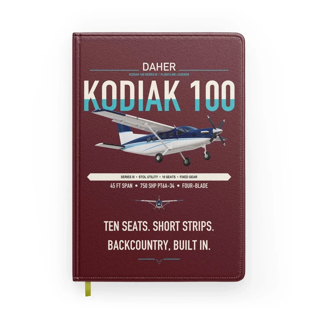 Daher Kodiak 100 Series III design on dark red notebook