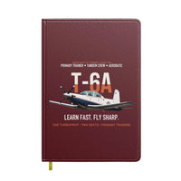 Thumbnail for T-6A Texan II Train The Next Generation design on dark red notebook