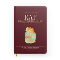 Thumbnail for Rapid City Regional Airport (RAP) design on dark red notebook