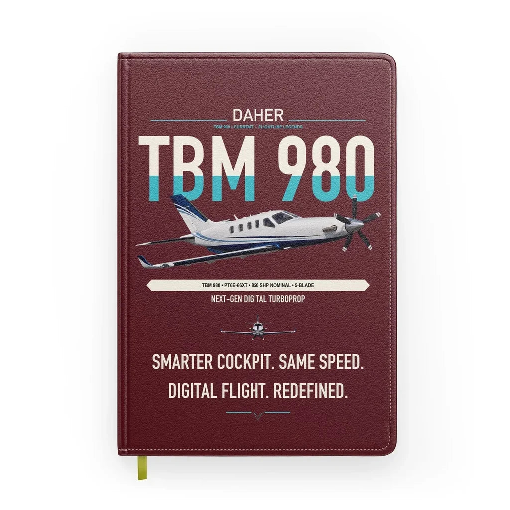 Daher TBM 980 design on dark red notebook